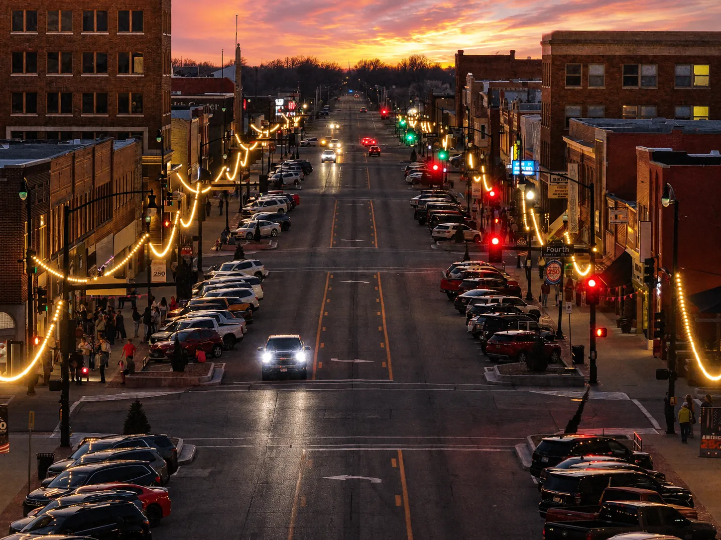 Downtown Ponca City at sunset — Grand Avenue lined with historic buildings and string lights